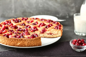 Tasty cranberry pie on table