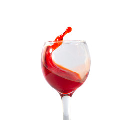 red wine splash in glass isolated