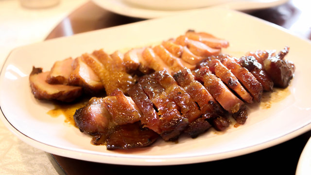 Closeup Of Honey Roasted Pork And Honey Roasted Duck On White Dish