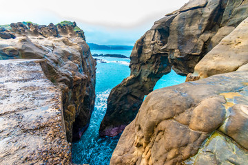 Fototapeta premium Beautiful seaside stone under the gloomy sky background. holiday concept. BEIJING, CHINA