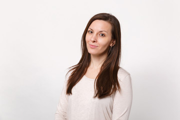 Obraz premium Portrait of smiling attractive young woman in light clothes standing and looking camera isolated on white wall background in studio. People sincere emotions lifestyle concept. Mock up copy space.
