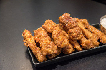 Korean style Fried chicken drumstick on black background.