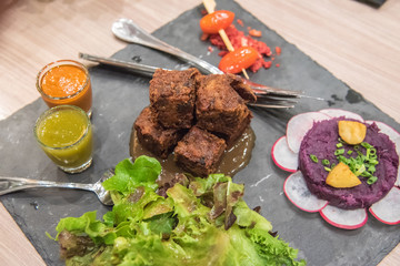 Pork hock in German with sauces delicious food, fried pork hock in black plate disc.