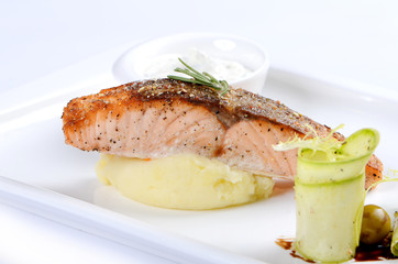 grilled salmon and mashed potatoes on the plate