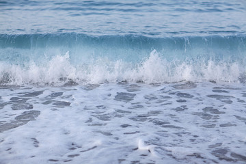 Sea waves and beach view at sunset, pastel colors. Concept of calm or relaxation. Summer background