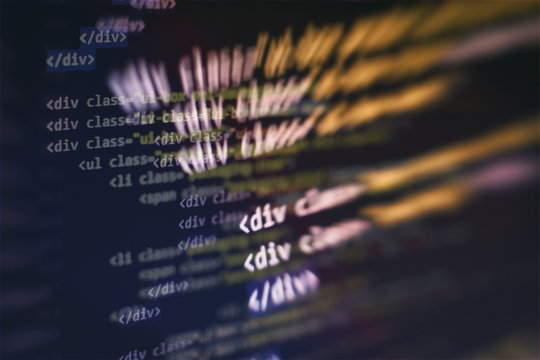 CSS, JavaScript and HTML usage. Monitor closeup of function source code. Abstract IT technology background. Software source code.