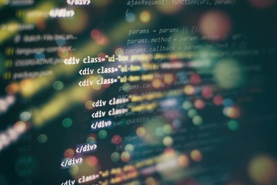 CSS, JavaScript and HTML usage. Monitor closeup of function source code. Abstract IT technology background. Software source code.