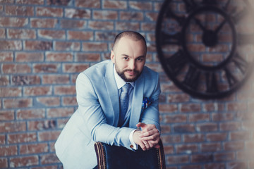 Handsome young man in full suit posing in studio