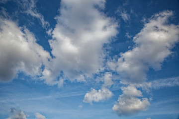 Beautiful blue sky with clouds of various shapes and colors.