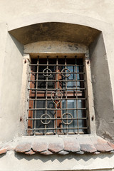 Fototapeta na wymiar Window with wrought-iron lattice Church of the Holy Apostle James at Sobotka in Lower Silesia