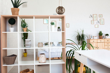 Cozy interior design of modern studio apartment in Scandinavian style. A spacious huge room in...