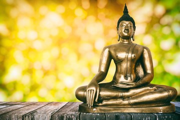Ancient Buddha Image on Wooden Table with Bokeh Background, Using Buddhist Religion Concept.