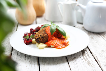Pumpkin cutlets served with tomato sauce on dumplings on gnocchi, roasted beet salad.