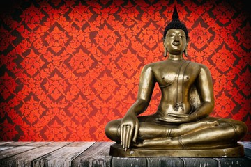 Ancient Buddha Image on Wooden Table with Ancient Vintage Thai Mural on Wall Background, Using Buddhist Religion Concept.