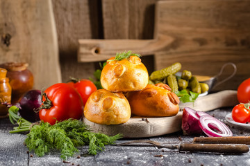 pies, loaf bread, dough on a wooden vintage cutting board old rustic, mustard sauce-dish, tomato,...