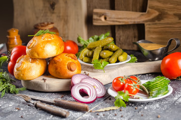pies, loaf bread, dough on a wooden vintage cutting board old rustic, mustard sauce-dish, tomato,...
