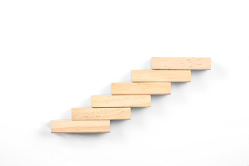 stairs concept; toy wood blocks make a stairs isolated on white background with copy space for your text