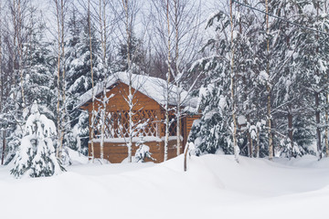 Wooden gazebo at a private house in the winter near the forest