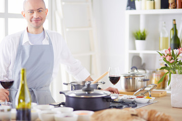 Couple cooking together in the kitchen at home