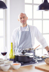 Couple cooking together in the kitchen at home