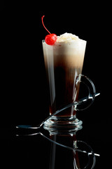 Layered coffee cocktail with whipped cream.