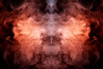 A multi-colored pattern of purple and blue smoke of a mystical shape in the form of a ghost's head or a strange creature on a black isolated background. Abstract pattern in of waves and steam.