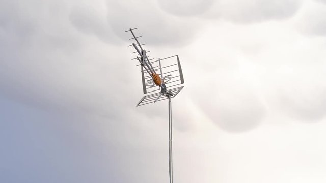 Timelapse of an UHF antenna on sky with clouds