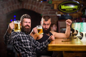 Alcohol drinks. Friends relaxing in pub with beer. Refreshing beer concept. Men drinking beer together. Hipster brutal man drinking beer with friend at bar counter. Men drunk relaxing having fun
