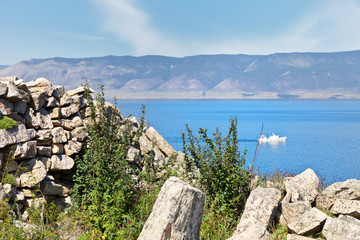 Fototapeta na wymiar Baikal Lake. Olkhon Island in summer sunny day. Cape Khorgoy is famous for the ruins of the ancient Kurykan Stone Wall one of archeological Siberian monuments
