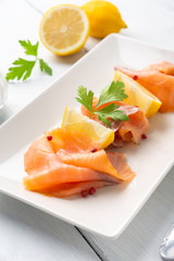 Piatto con fette di salmone affumicato e limone fresco