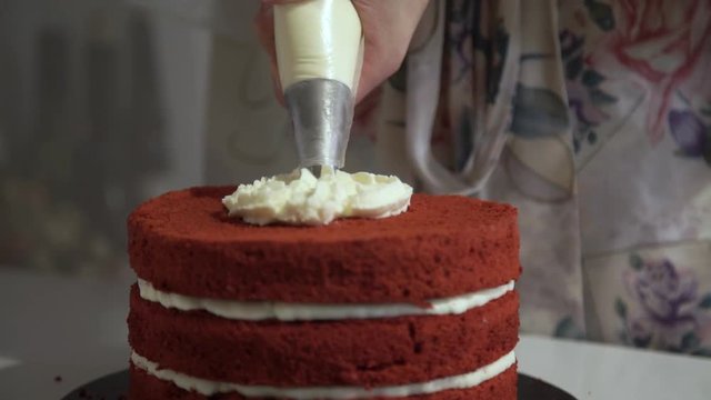 Making red velvet cake at home. Cream cake decoration
