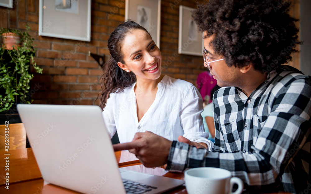 Wall mural multiethnic people meeting at cafe, advisor showing offer to client on laptop