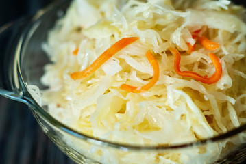 salad homemade sauerkraut in a glass jar on a table