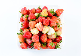 a punnet of strawberries on white background