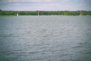 Lake landscape with cloud reflections. Blue sky and reflected in the lake water landscape