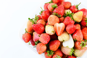 a punnet of strawberries on white background
