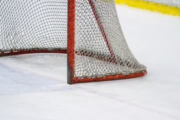 Red, old ice hockey rink goal net.