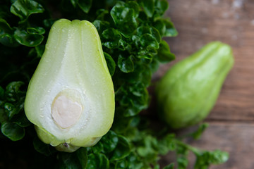 Fresh chayote fruits (Sechium edulis) on wood background