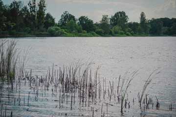Lake landscape with cloud reflections. Blue sky and reflected in the lake water landscape