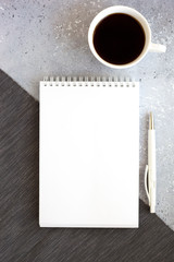 Business Workplace in a minimalist style with cup of coffee, notebook and pen.
