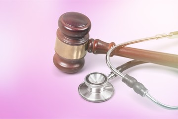 Gavel and stethoscope  on background, symbol photo for bungling and medical error