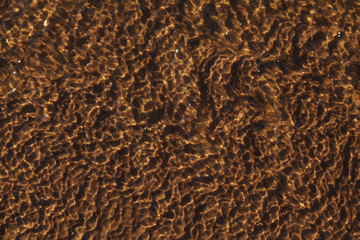 Nature design of reflection on nature pattern sand under sea water. Sand under water in nature as background