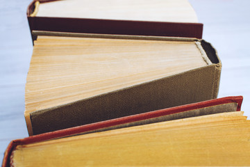 Book background. Top view of open hardback books on wooden table. Education, literature, knowledge, Back to school. Copy space