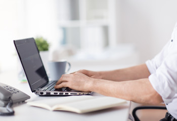 Fototapeta premium business, people and technology concept - close up of businessman typing on laptop computer keyboard at office