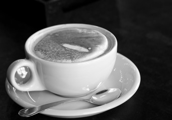 Cup of cappuccino on a black background