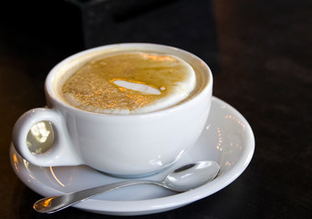 Cup of cappuccino on a black background