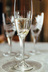 a glass of champagne and wedding rings.