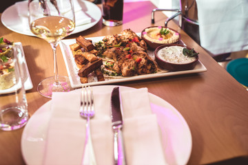 Table with various arabic food served in restaurant
