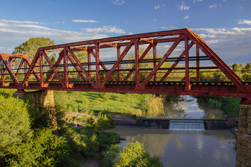 Old steel bridge over a small African river