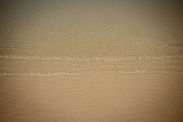 Small waves lapped the beach